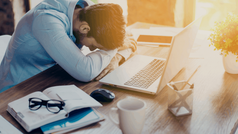 Man with head on desk