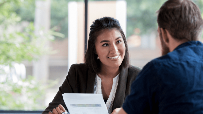 Smiling woman talking to client