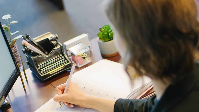 Woman writing at desk